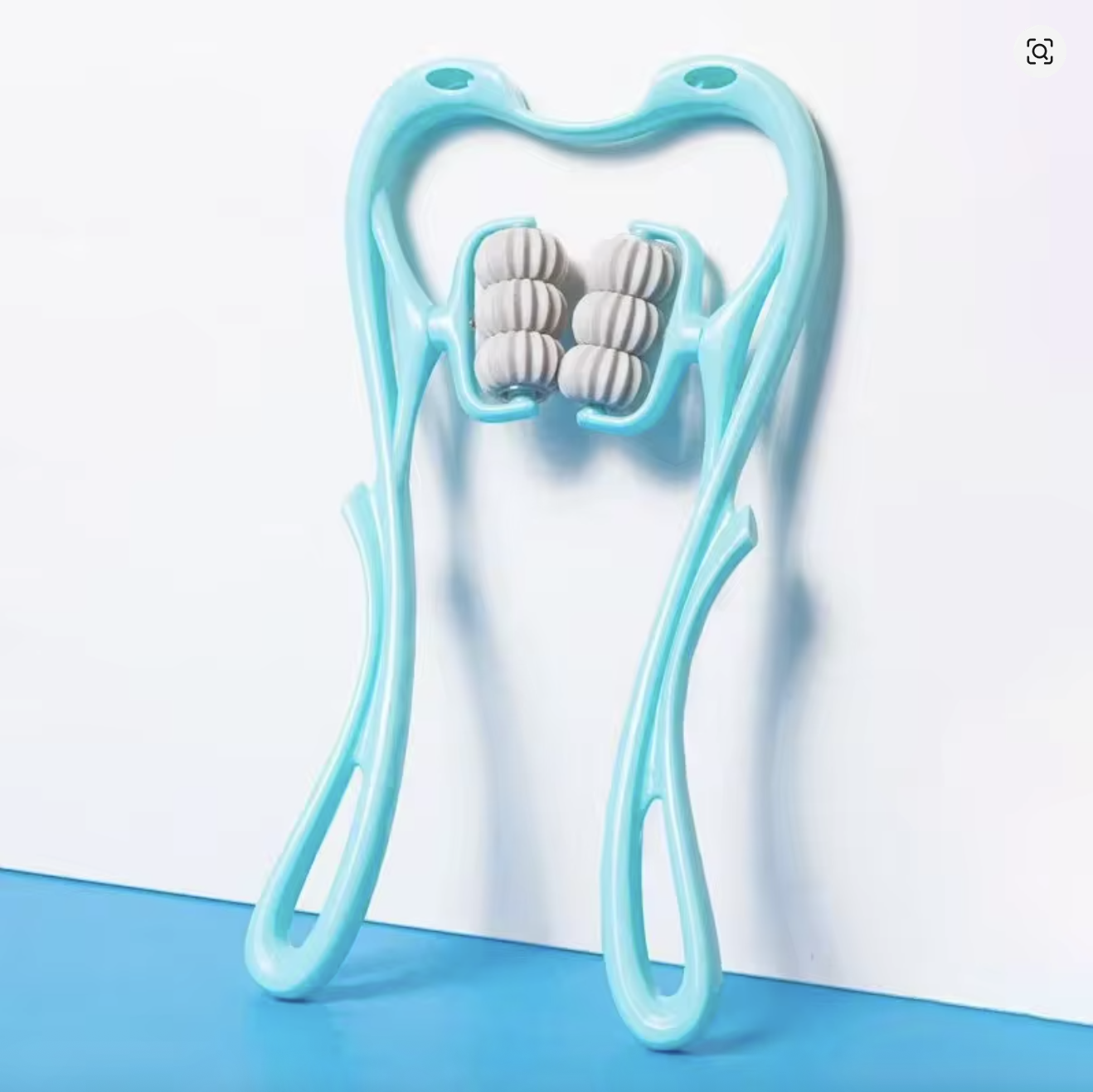 The NODE Swan 6-Roller neck massager standing upright on a white and blue backdrop
